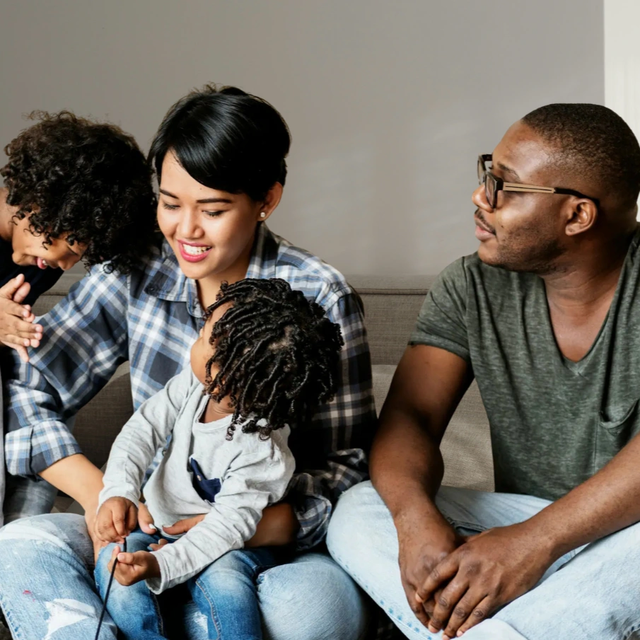 Family sitting together in a supportive home environment, representing school family support services